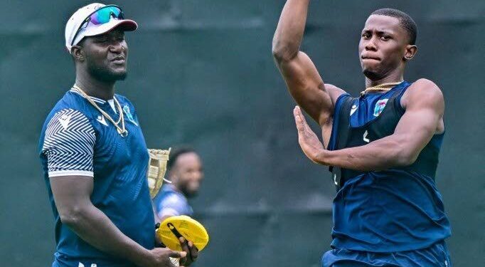 (FILE) West Indies’ pacer Shamar Joseph bowls as head coach Daren Sammy looks on during a practice session on the eve of their second one-day international against Sri Lanka at the Pallekele International Cricket Stadium in Kandy on October 22, 2024. - FILE PHOTO