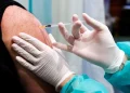 A doctor inoculates a patient with a vaccine against Coronavirus. Carsten Koall/dpa
