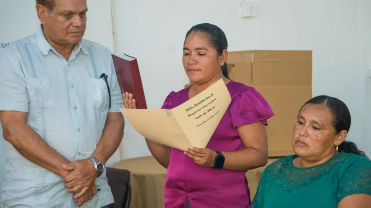 Region Eight Regional Chairperson Tarcellia John (taking the oath) and Vice Chairperson Samantha John (sitting)