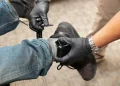 An ankle monitoring bracelet is being attached to allow tracking.