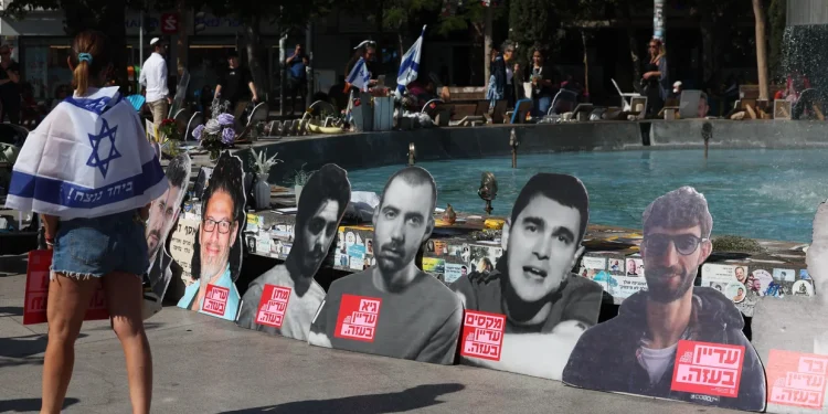 People walk past portraits of Israelis held hostage in the Gaza Strip since 2023, during a rally in Tel Aviv marking two years since the Hamas terrorist attack, Oct. 7, 2025.
AHMAD GHARABLI/AFP/Getty