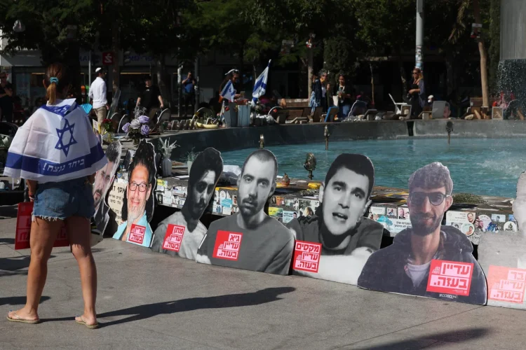 People walk past portraits of Israelis held hostage in the Gaza Strip since 2023, during a rally in Tel Aviv marking two years since the Hamas terrorist attack, Oct. 7, 2025.
AHMAD GHARABLI/AFP/Getty