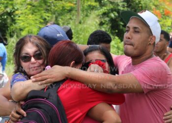 Venezuelan migrants console each other after seeing off a group of 97 Venezuelans including their family members and friends who were being deported in August 2023. FILE PHOTO/GREVIC ALVARADO Relatives console each other after 97 Venezuelans were deported on Saturday. -
