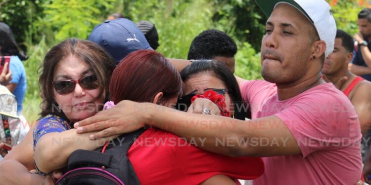 Venezuelan migrants console each other after seeing off a group of 97 Venezuelans including their family members and friends who were being deported in August 2023. FILE PHOTO/GREVIC ALVARADO Relatives console each other after 97 Venezuelans were deported on Saturday. -