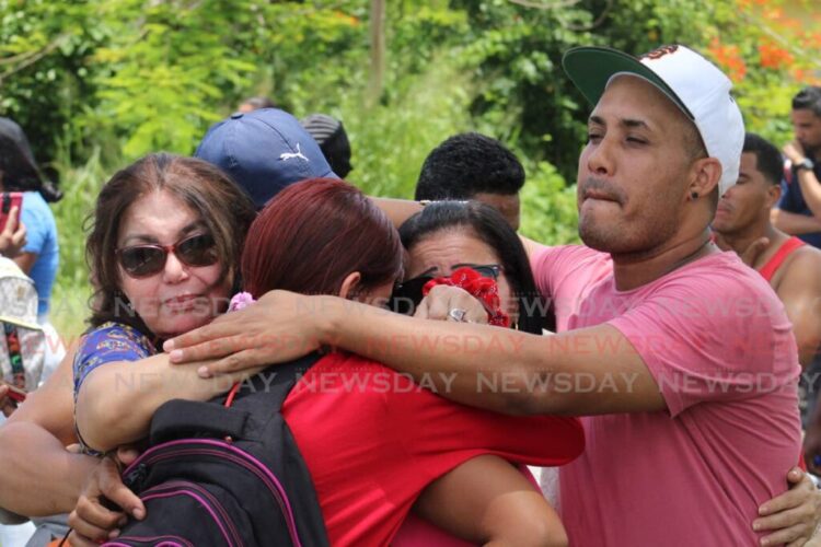 Venezuelan migrants console each other after seeing off a group of 97 Venezuelans including their family members and friends who were being deported in August 2023. FILE PHOTO/GREVIC ALVARADO Relatives console each other after 97 Venezuelans were deported on Saturday. -