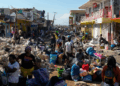 Community members sift through storm-tossed debris in Black River, Jamaica, days after Hurricane Melissa swept the coast. Photo Credit - Matias Delacroix