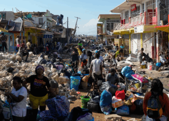 Community members sift through storm-tossed debris in Black River, Jamaica, days after Hurricane Melissa swept the coast. Photo Credit - Matias Delacroix