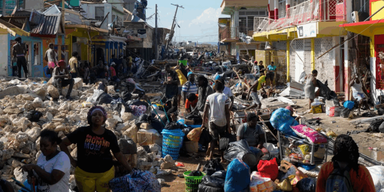 Community members sift through storm-tossed debris in Black River, Jamaica, days after Hurricane Melissa swept the coast. Photo Credit - Matias Delacroix