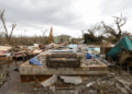 Community members sift through storm-tossed debris in Black River, Jamaica, days after Hurricane Melissa swept the coast. Photo Credit - Matias Delacroix