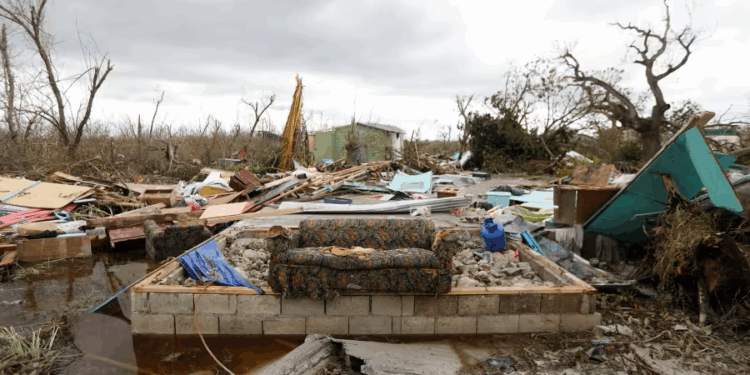 Community members sift through storm-tossed debris in Black River, Jamaica, days after Hurricane Melissa swept the coast. Photo Credit - Matias Delacroix