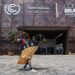 A performer wearing traditional attire poses for a photo in front of the COP30 venue in Belem, Brazil, Nov. 6, 2025. (Xinhua/Wang Tiancong)