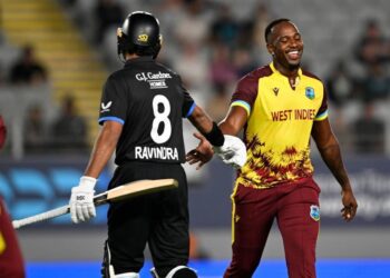New Zealand’s Rachin Ravindra (L) gestures to West Indies bowler Matthew Forde during the T20 match in Auckland, New Zealand, on November 5. - AP Photo