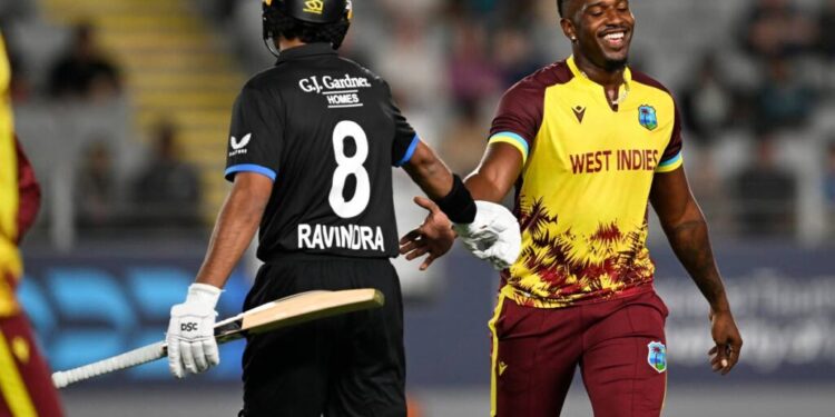 New Zealand’s Rachin Ravindra (L) gestures to West Indies bowler Matthew Forde during the T20 match in Auckland, New Zealand, on November 5. - AP Photo