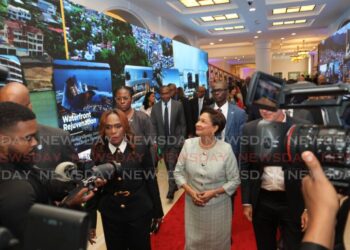 Prime Minister Kamla Persad-Bissessar, centre, accompanied by Works Minister Jearlean John and other government officials at the launch of the TT Revitalisation Blueprint, at the Diplomatic Centre, St Ann's, PoS on November 7. - File photo by Faith Ayoung