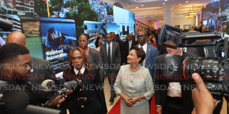 Prime Minister Kamla Persad-Bissessar, centre, accompanied by Works Minister Jearlean John and other government officials at the launch of the TT Revitalisation Blueprint, at the Diplomatic Centre, St Ann's, PoS on November 7. - File photo by Faith Ayoung