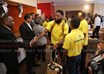 Cletus Bertin, executive director of CARILEC, left, greets TTEC's aid team at the Diplomatic Lounge, Piarco airport, on November 10, as they leave for Jamaica to support the Hurricane Melissa recovery. - Photo by Faith Ayoung