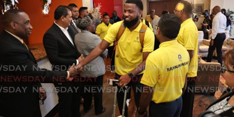 Cletus Bertin, executive director of CARILEC, left, greets TTEC's aid team at the Diplomatic Lounge, Piarco airport, on November 10, as they leave for Jamaica to support the Hurricane Melissa recovery. - Photo by Faith Ayoung