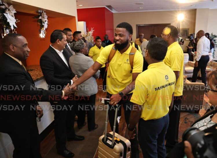 Cletus Bertin, executive director of CARILEC, left, greets TTEC's aid team at the Diplomatic Lounge, Piarco airport, on November 10, as they leave for Jamaica to support the Hurricane Melissa recovery. - Photo by Faith Ayoung