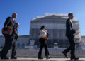Members of the public walk outside the U.S. Supreme Court to attend oral arguments on U.S. President Donald Trump's bid to preserve sweeping tariffs after lower courts ruled that Trump overstepped his authority, in Washington, D.C., U.S., November 5, 2025. REUTERS/Nathan Howard Purchase Licensing Rights