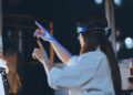 A young woman is using VR glasses. /VCG
