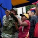 A member of the Bolivarian National Militia shows a woman how to operate a weapon during military exercises in Caracas, Venezuela, Saturday, Sept. 20, 2025. | AP Photo/Ariana Cubillos