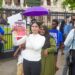 Hana Mohamed (in white) hold a photo of Speaker Manzoor Nadir (Team Mohamed's photo)