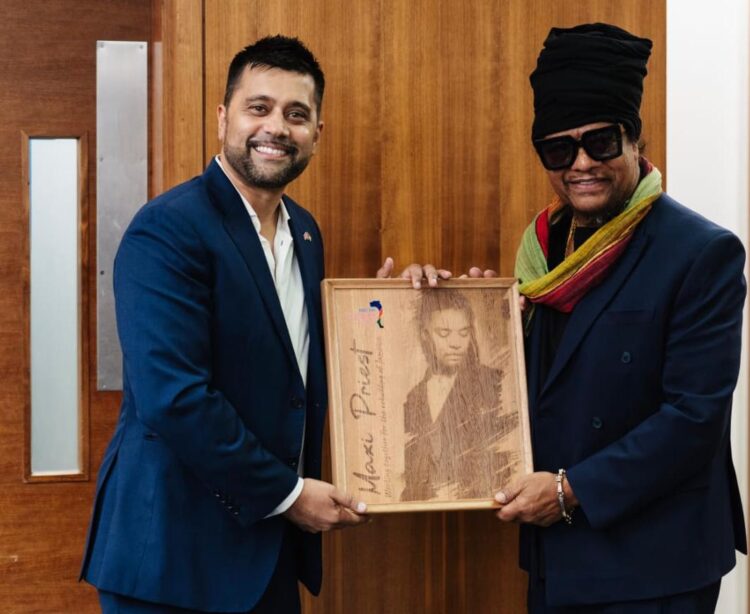 Maxi Priest and Faizal Khan with Signed Maxi Priest Greenheart Wooden Engraved Plaque created by Branderz Guyana
