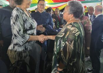 CARICOM Secretary-General, Dr Carla Barnett (R) greets the President of Suriname, H.E. Jennifer Geerlings Simons (L) at a reception the President hosted ahead of her country's Jubilee Anniversary of Independence on 24 November.