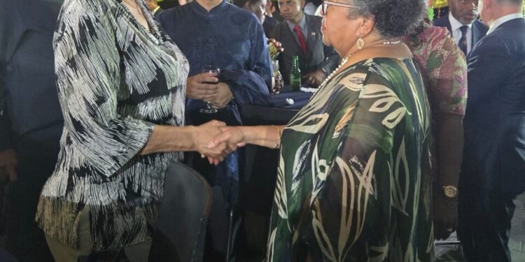 CARICOM Secretary-General, Dr Carla Barnett (R) greets the President of Suriname, H.E. Jennifer Geerlings Simons (L) at a reception the President hosted ahead of her country's Jubilee Anniversary of Independence on 24 November.
