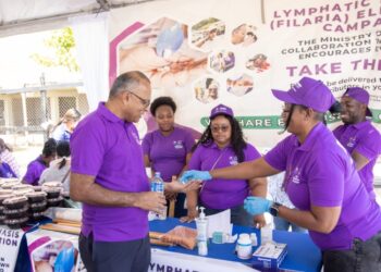 Minister of Health Dr Frank Anthony receiving his filaria pills