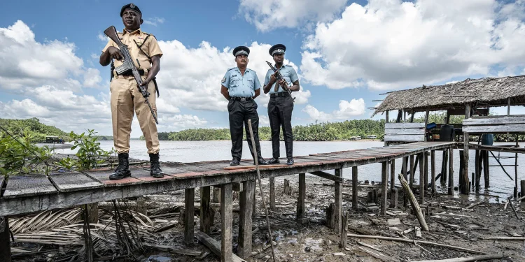Inspector Marcel Sandy, Sgt Charles Walker, left, and Constable Alester Prestano on the Guyanese border at Imbotero Credit: Simon Townsley