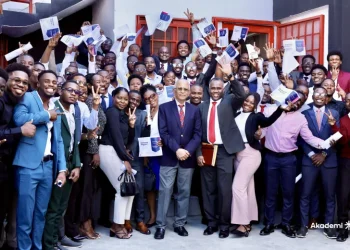 Students, holding their certificates of completion from the Akademi bootcamp, posed for photos with Quisqueya University Rector Jacky Lumarque and Vice-Rector Evenson Calixte after the ceremony in Port-au-Prince on November 9, 2025. Photo courtesy of Akademi.