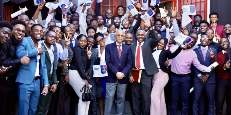 Students, holding their certificates of completion from the Akademi bootcamp, posed for photos with Quisqueya University Rector Jacky Lumarque and Vice-Rector Evenson Calixte after the ceremony in Port-au-Prince on November 9, 2025. Photo courtesy of Akademi.