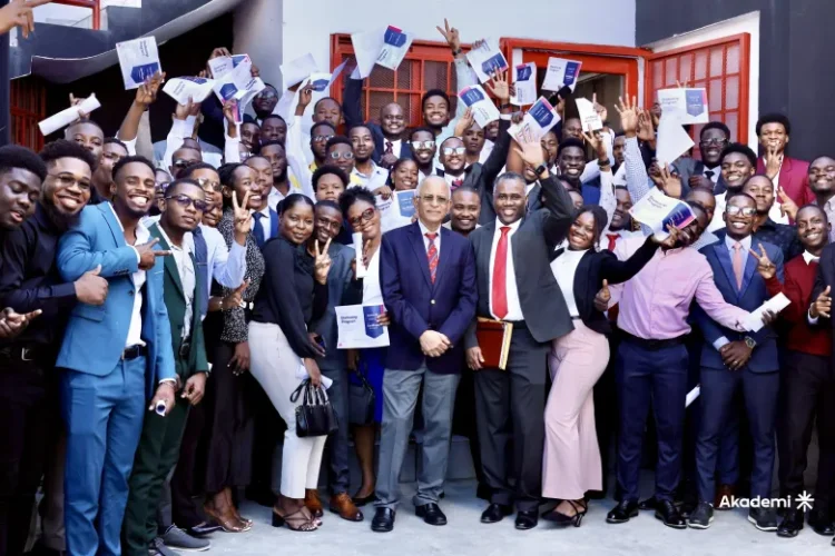 Students, holding their certificates of completion from the Akademi bootcamp, posed for photos with Quisqueya University Rector Jacky Lumarque and Vice-Rector Evenson Calixte after the ceremony in Port-au-Prince on November 9, 2025. Photo courtesy of Akademi.