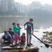 © UNICEF/Jannatul Mawa Children cross a polluted lake on a homemade raft in the Korail slum of Dhaka, Bangladesh.