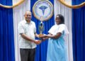 Minister of Health, Dr. Frank Anthony, presented the Valedictorian Trophy to Ms. Michelle Boyer in recognition of her outstanding performance during the Patient Care Assistant training programme