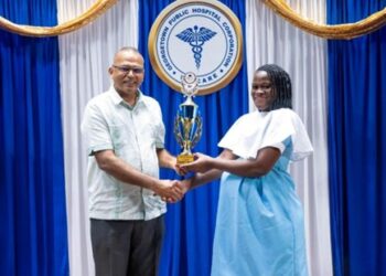 Minister of Health, Dr. Frank Anthony, presented the Valedictorian Trophy to Ms. Michelle Boyer in recognition of her outstanding performance during the Patient Care Assistant training programme