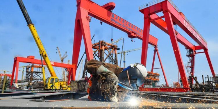 A worker prefabricates steel for Bohai Oilfield platform at an intelligent manufacturing base in Tianjin, north China, March 30, 2025. (Photo by Du Penghui/Xinhua)