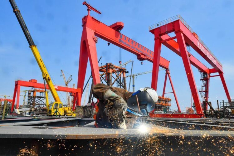 A worker prefabricates steel for Bohai Oilfield platform at an intelligent manufacturing base in Tianjin, north China, March 30, 2025. (Photo by Du Penghui/Xinhua)