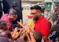 screengrab of President Irfaan Ali sharing out toys in Albouystown