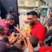 screengrab of President Irfaan Ali sharing out toys in Albouystown