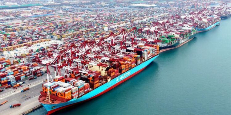 This aerial drone photo taken on Dec. 27, 2025 shows cargo ships loading and unloading containers at Qingdao Port in east China's Shandong Province. (Photo by Yu Fangping/Xinhua)