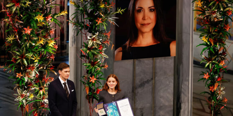 Ana Corina Sosa (R), daughter of Venezuelan opposition leader Maria Corina Machado, receives the Nobel Peace Prize for her mother from the Chair of the Norwegian Nobel Committee Jorgen Watne Frydnes.Odd Andersen / AFP via Getty Images