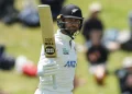 Devon Conway raises his bat after getting to his first half-century against West Indies  •  Getty Images