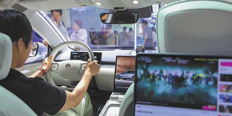 A visitor gets to grips with a Nio cabin at the World Artificial Intelligence Conference in Shanghai in July 2024. CHINA DAILY
