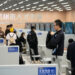 Jobseekers gather information at an employer's stand during a job fair held in Hangzhou, Zhejiang province, on Nov 12. [Photo/Xinhua]