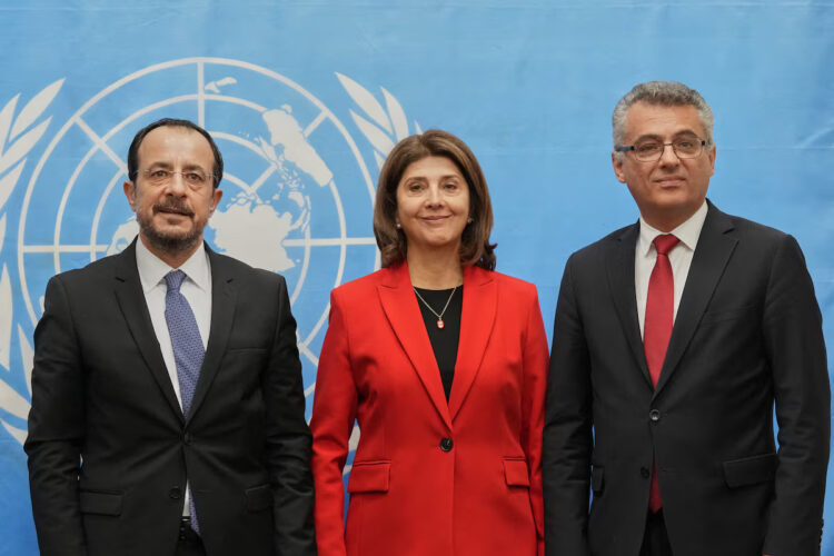 Republic of Cyprus President Nikos Christodoulides, United Nations Secretary-General's Personal Envoy on Cyprus, Maria Angela Holguin Cuellar, and Turkish Cypriot leader Tufan Erhurman pose for a photograph at the U.N. compound inside the UN buffer zone, in Nicosia, Cyprus, December 11, 2025. Petros Karadjias/Pool via REUTERS Purchase Licensing Rights