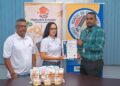 Founders, Mark Singh and Alyssa Singh, receive the GNBS Made in Guyana Certificate from Head of Certification Services Dept. (ag), Keon Rankin