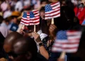 New US citizens use handheld fans to take shade from the sun during a naturalization ceremony at George Washington's Mount Vernon in Mount Vernon, Virginia, US, on Friday, July 4, 2025. Kent Nishimura/Bloomberg via Getty ImagesKent Nishimura—Bloomberg via Getty Images