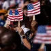 New US citizens use handheld fans to take shade from the sun during a naturalization ceremony at George Washington's Mount Vernon in Mount Vernon, Virginia, US, on Friday, July 4, 2025. Kent Nishimura/Bloomberg via Getty ImagesKent Nishimura—Bloomberg via Getty Images
